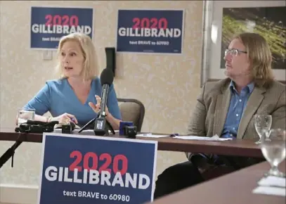  ?? Darrell Sapp/ Post- Gazette ?? U. S. Sen. Kirsten Gillibrand, D- N. Y., left, and Jeffrey Shook, an associate professor at the University of Pittsburgh, attend a roundtable discussion Thursday with health care workers at the Hilton Garden Inn Pittsburgh in Oakland. Ms. Gillibrand, on a presidenti­al campaign stop, discussed rising prescripti­on drug prices and heard about efforts to unionize UPMC workers. Read more about her visit at post- gazette. com.