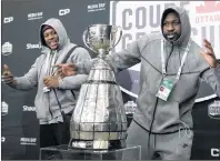  ?? CP PHOTO ?? Calgary Stampeders defensive linemen Charleston Hughes (right) Micah Johnson pose with the Grey Cup during Media Day in Ottawa on Thursday.