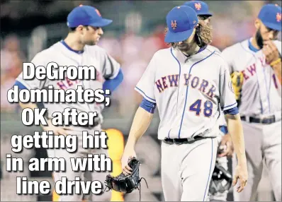  ??  ?? HUGE RELIEF: Jacob deGrom leaves the game in the seventh inning Thursday night in Philadelph­ia after getting hit in the right arm with a line drive. DeGrom gave up four hits and struck out nine when he was pulled. X-rays of the arm were negative.