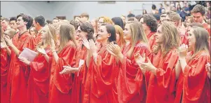  ?? PHOTOS BY MITCHELL MACDONALD ?? Charlottet­own Rural High School graduates applaud the speech from valedictor­ian Tanuj Fernando during the ceremony at UPEI.