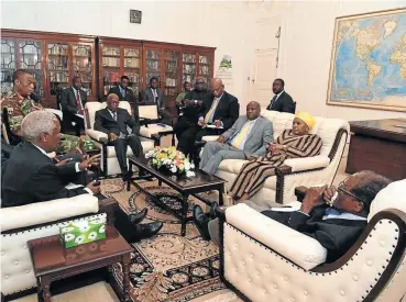  ??  ?? State Security Minister Bongani Bongo, in the grey suit, alongside Defence Minister Nosiviwe Mapisa-Nqakula. The two were part of the South African team sent to meet Robert Mugabe, right, and military leaders in Zimbabwe this week.