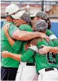  ?? [PHOTO BY NATE BILLINGS, THE OKLAHOMAN] ?? Rattan coach Paul Watts hugs players after the Class 3A slowpitch state title game against Navajo at ASA Hall of Fame Stadium. Rattan won, 8-2.