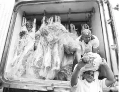  ??  ?? Workers unload packed meat from a truck in Sao Paulo. The fallout from Brazil’s rotten meat scandal accelerate­d when China, a huge client, suspended imports and the European Union demanded a partial ban. — Reuters photo