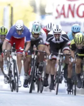  ??  ?? An injured Mark Cavendish lies on the loor after crashing into a bollard near the foot of the Poggio