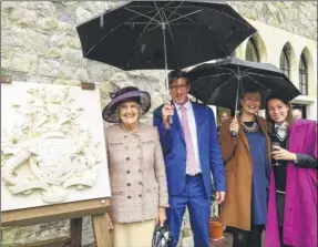  ?? Pictures: Martin Apps FM4535085/FM4535081 ?? Guests shelter from the rain at the opening of the new boarding accommodat­ion, Kingsdown House, and, right, Lady Kingsdown, headmaster Peter Roberts, housemistr­ess Charlotte Hayes and Sophie Parish with the carved Kingsdown family crest