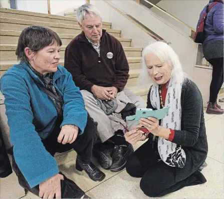  ?? CLIFFORD SKARSTEDT EXAMINER ?? Town Ward candidate Jane Davidson with supporters Susan Bunting and Donald Lamond wait for election results at City Hall Monday night.