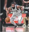  ?? AP ?? Dallas Mavericks guard Kyrie Irving drives to the basket during the team's NBA game against the Brooklyn Nets in New York on Tuesday.