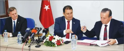  ??  ?? YDP leader Erhan Arıklı, UBP interim leader Hamza Ersan and DP leader Fikri Atatoğlu during the signing of the ‘government protocol’ in the Parliament building on Tuesday