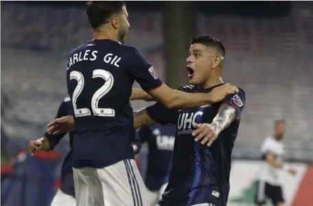  ?? ASSOCIATED PRESS ?? WELCOME SIGHT: Newcomer Gustavo Bou (right) celebrates his goal with Carles Gil in the Revolution’s 4-0 victory against Vancouver last night at Gillette Stadium.