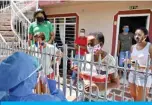  ??  ?? CALI: Health workers wearing biosafety suits take a test of a local family during a checkup for the COVID19 novel coronaviru­s at Nueva Floresta neighborho­od in Cali, Colombia. — AFP