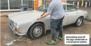  ??  ?? Jetwashing mud off the Jag’s underside at a local petrol station.