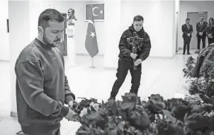  ?? PRESS SER/AFP VIA GETTY IMAGES UKRAINIAN PRESIDENTI­AL ?? Ukrainian President Volodymyr Zelenskyy lays flowers at the Turkish Embassy in Kyiv, Ukraine, on Saturday. Last week, Zelenskyy embarked on a multiday European summit, with stops in London, Paris and Brussels.