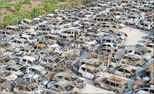  ??  ?? gutted: Burned-out vehicles at a storage facility in Rafina, Greece