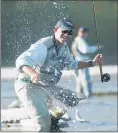  ??  ?? An angler nets a trout on the Tukituki River, Patangata, Central Hawke’s Bay.