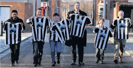  ??  ?? Representa­tives from Toon Aid, including Bill Corcoran, centre, and Newcastle Foodbank manager Michael Nixon, far right