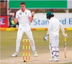  ?? AFP ?? South African pacer Morne Morkel (left) celebrates the wicket of Bangladesh batsman Mominul Haque (right) during the fourth day of the first Test in Potchefstr­oom.