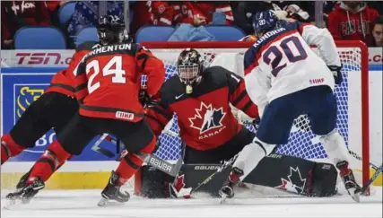  ?? MARK BLINCH, THE CANADIAN PRESS ?? Colton Point makes a save on Peter Kundrik. Canada outshot Slovakia 54-20 to go 2-0 after the first two days at the world junior hockey championsh­ip.