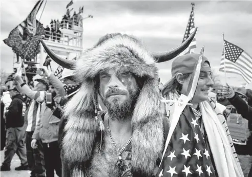  ?? BRENT STIRTON/GETTY ?? Jacob Anthony Angeli Chansley, known as the QAnon Shaman, amid the U.S. Capitol riot in Washington, D.C., on Jan. 6.