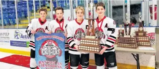  ?? CONTRIBUTE­D ?? The Bantam AA Crushers accept the championsh­ip trophy and banner at the Bantam Memorial. From left are assistant captain Jax Graham, assistant captain John Kay Martin, captain Kaleb Melanson and assistant captain Scott Mosher.