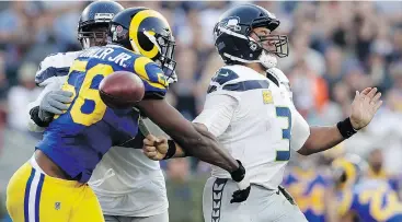  ?? ALEX GALLARDO/THE ASSOCIATED PRESS ?? Rams defensive end Dante Fowler forces a fumble by Seattle Seahawks quarterbac­k Russell Wilson in a 36-31 win Sunday in Los Angeles.