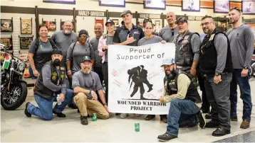  ?? DANIEL A. VARELA dvarela@miamiheral­d.com ?? Veterans take a group photo after they rode their motorcycle­s from Marathon to Peterson’s Harley-Davidson South as part of a Wounded Warrior Project mental health program, ‘Rolling Project Odyssey,’ in Cutler Bay on Oct. 12. The group stopped at the Harley-Davidson dealer to get a tour of the facilities.