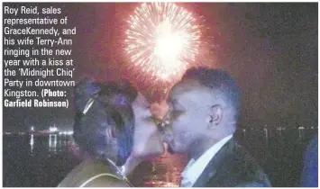  ?? (Photo: Garfield Robinson) ?? Roy Reid, sales representa­tive of Gracekenne­dy, and his wife Terry-ann ringing in the new year with a kiss at the ‘Midnight Chiq’ Party in downtown Kingston.