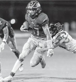  ?? William Luther / Staff photograph­er ?? Wimberley’s Juan Olmedo tries to get past Navarro’s Ryatt Kluckman during the first half. Olmedo scored on an 11-yard touchdown run and had a 52-yard punt return to set up a field goal.