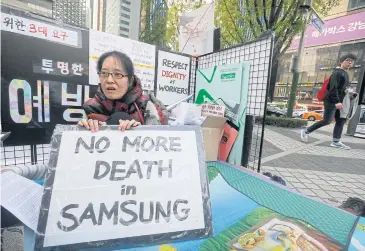  ?? AP ?? Former Samsung worker Han Hye-kyung denounces the company’s response in its negotiatio­ns with sick workers during an October protest in Seoul. She became disabled after surgery to remove a brain tumour.