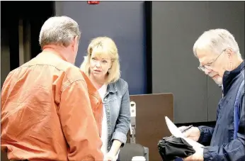  ?? Michael Burchfiel/Herald-Leader ?? Representa­tive Robin Lundstrum (middle) listened to concerns from two District 87 residents after Saturday’s legislativ­e briefing.