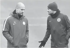  ??  ?? Manchester City manager Pep Guardiola (left) and Ilkay Gundogan during training at club’s training ground in Manchester. — Reuters photo