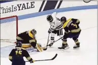  ?? Steve Musco / Yale Athletics ?? Quinnipiac goalie Yaniv Perets and defenseman Jake Johnson (3) stop Yale forward Henry Wagner in the second period.