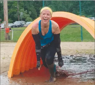  ?? Photos by Jonathan Bissonnett­e ?? Above: Olivia Foley of North Attleboro emerges from the mud pool at the Reviver Challenge.