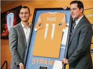  ?? Brett Coomer / Houston Chronicle ?? Longtime Dynamo midfielder Brad Davis, left, signed a oneday contract to retire with the team he spent a decade with Thursday. Davis, who was the club’s leader in five categories, helped lead the Dynamo to two MLS Cup titles and two other Cup finals.