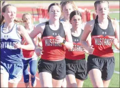  ?? RICK PECK/SPECIAL TO MCDONALD COUNTY PRESS ?? McDonald County’s Anna Belle Price, Madison Burton and Melysia McCrory (left to right) run together in the 1600meter run at the McDonald County JV Stampede held on March 29 at McDonald County High School. McCrory finished fourth in the race, while Price was eighth and Burton took ninth.