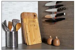  ??  ?? For The Washington Post/STACY ZARIN GOLDBERG Save counter space by storing knives on a magnetic strip, rather than in a knife block, and by leaning cutting boards against the backsplash, where the wood can create visual warmth.