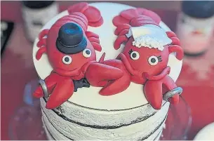  ?? TRAVIS DUTKIEWICZ PHOTOS ?? Travis and Tara Dutkiewicz tied the knot in front of a lobster tank at a local grocery store in Red Deer, Alta., where they first met.