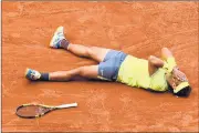  ?? CLIVE MASON/GETTY ?? Rafael Nadal hits the dirt after match point in his victory over Dominic Thiem for his record 12th French Open title.