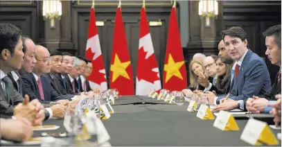  ?? Jacques Boissinot ?? The Associated Press Prime Minister Justin Trudeau, right, meets with the Prime Minister of Vietnam, third from left, Nguyen Xuan Phuc, during a G-7 meeting Sunday in Quebec City. President Donald Trump took more swipes at Trudeau on Monday as his...