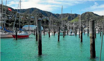  ?? PHOTOS: STUFF; SUPPLIED ?? Above, Tim Carter and Brendan Prendergas­t confirm the Move Logistics deal; right, work is under way to replace the old piles at Te Ana marina with a walk-on facility. The old woolshed building (blue roof) will be redevelope­d.