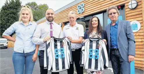  ??  ?? A new Co-op store opened in Cwmbach last week – and revealed the new kit for AFC Llwydcoed which it is sponsoring