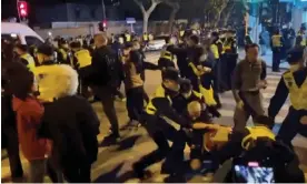  ?? Photograph: Video Obtained By Reuters/Reuters ?? Police officers detain people during a protest against Covid curbs in Shanghai.