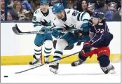  ?? PAUL VERNON — THE ASSOCIATED PRESS ?? Blue Jackets forward Carson Meyer, right, collides with Sharks forward Ryan Carpenter during Saturday's game.