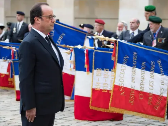  ??  ?? The President at a ceremony in Paris on Sunday honouring Harkis who served in the Algerian War, tens of thousands of whom were massacred when the French deserted them (EPA)