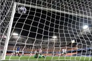  ?? ASSOCIATED PRESS PHOTO ?? Atalanta’s Josip Ilicic scores his side’s third goal during the Champions League round of 16 second leg soccer match between Valencia and Atalanta in Valencia, Spain, on Tuesday March 10, 2020. The match was played in an empty stadium because of the coronaviru­s outbreak.