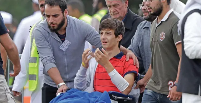  ??  ?? Zaed Mustafa, in wheelchair, brother of Hamza and son of Khalid Mustafa who were killed in the Friday, March 15 mosque shooting, during their burial at the Memorial Park Cemetery in Christchur­ch, on New Zealand, Wednesday, March 20, 2019.