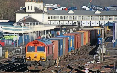  ?? MARK PIKE. ?? With a car transporte­r crossing a bridge in the background, DB Cargo 66149 passes Eastleigh with the 0643 Birch Coppice-Southampto­n Western Docks on January 19. Rail Freight Group Chairman Lord Berkeley says the industry needs to ‘get real’ when it...