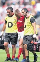  ??  ?? Gareth Anscombe leaves the field injured against England last year.