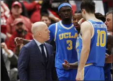  ?? YOUNG KWAK — THE ASSOCIATED PRESS ?? UCLA head coach Mick Cronin, left, disputes a flagrant foul call with an official during a game against Washington State on March 2 in Pullman, Wash.