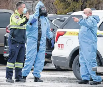  ?? KATHY JOHNSON ?? Hazmat team members talks with EHS while on scene at the Barrington Municipal Administra­tive Centre on Feb. 7 to retrieve a suspicious package suspected to contain a chemical irritant from South Shore St. Margaret's MP Rick Perkins' office.