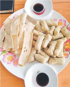  ??  ?? Fatimah’s sausage-shaped keropok lekor (right) and keropok keping (left) to be eaten with her special sauce.